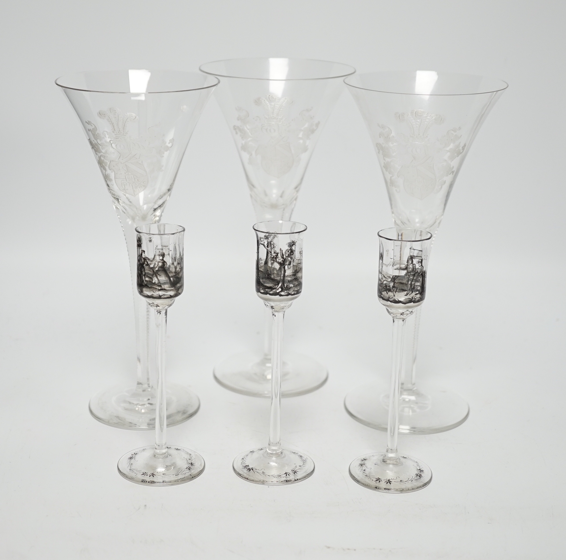 Set of three armorial crest etched flutes and three enamelled liqueur glasses, largest, 23cm high
